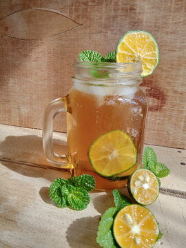  Natural Fresh Orange Iced Tea On A Wooden Table