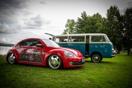 Moscow, Russia - July 13, 2019: T1 transporter and beetle. Two restored retro cars on the lake.