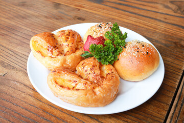 Fresh homemade bread on white plate.