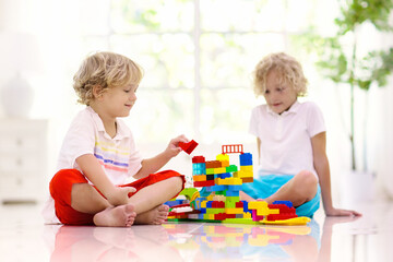 Naklejka premium Child playing with toy blocks. Kids play.