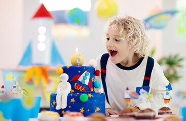 Kids space theme birthday party with cake.