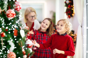 Obraz na płótnie Canvas Family decorating Christmas tree. Kid on Xmas eve.
