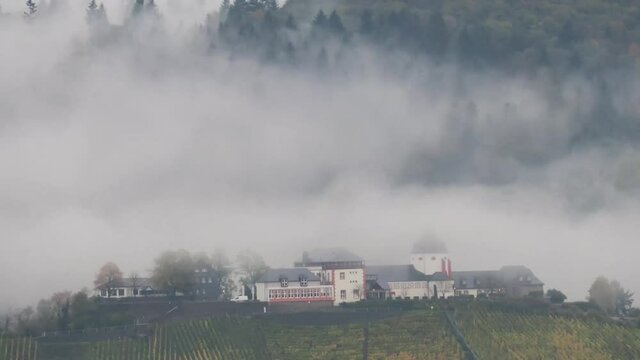 German castle near the river moezel time-lapse. The fog disappears from the castle grounds.