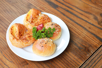 Fresh homemade bread on white plate.