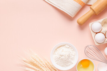 Ingredients for baking on light pink background.