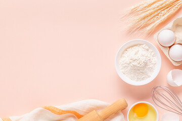 Ingredients for baking on light pink background.