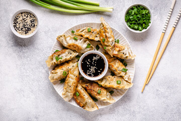 Fried dumplings gyoza with soy sauce, and chopsticks.