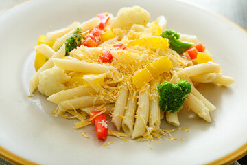 Tasty pasta primavera on plate, closeup