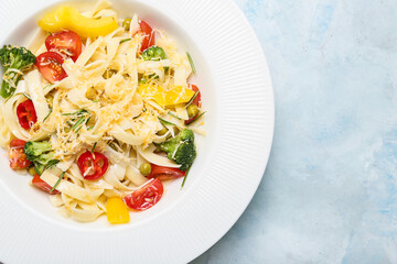 Plate with tasty pasta primavera on color background