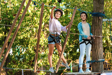 Teenagers climbing in adventure park
