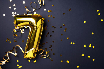Gold foil balloon number and digit seven 7. Birthday greeting card. Anniversary celebration event....