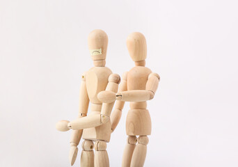 Wooden mannequins on light background. Concept of violence