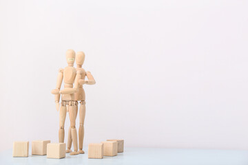 Wooden mannequins on light background. Concept of violence