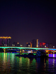 Fototapeta na wymiar Night view of river view bridge city in Nanning, Guangxi, China