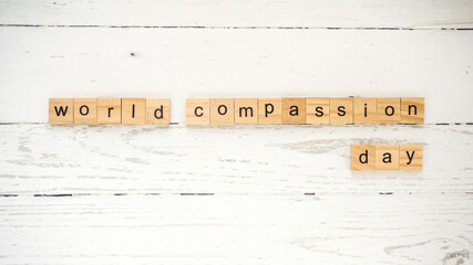 World Compassion Day.words from wooden cubes with letters photo