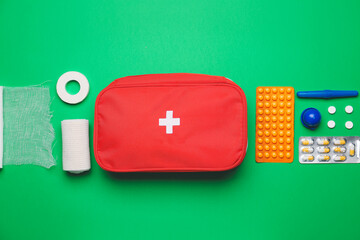 First aid kit on color background