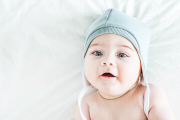 Toddler boy newborn naked in green beanie on bed - Powered by Adobe