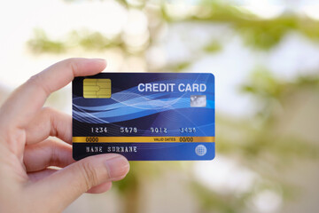 A woman holding a credit card. Warm tone images. Suitable for illustration.
