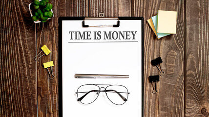 TIME IS MONEY text form on a wooden table with office tips