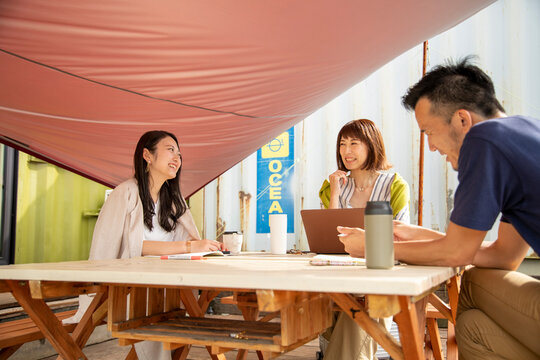 Man and Women Having a Meeting on an Outdoor Office as New Normal Work Style