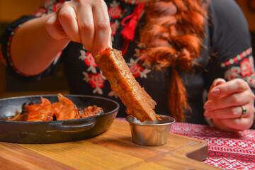 Delicious dinner and clean eating concept from above. Fried meat in a pan, on vintage background flat-lay.