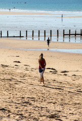 Romantic walk of people on the picturesque beach of Saint Malo. Brittany, France