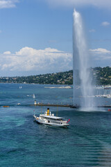 vintage steamboat leaving the harbor with the water jet in Geneva, Switzerland	