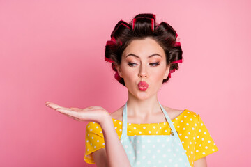 Close-up portrait of her she attractive girlish housewife holding on palm copy space pout lips advert isolated over pink pastel color background