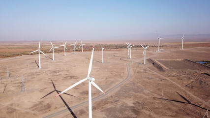 Windmills in the steppe. Near a small town. Alternative, clean energy. Top view from the drone on...