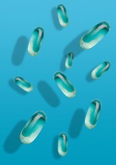 Falling transparent fish oil pills on different planes against a blue uniform background. Vitamins and pills.