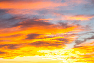 Dramatic yellow and orange colored sunset cloudscape for background or sky replacement photo editing