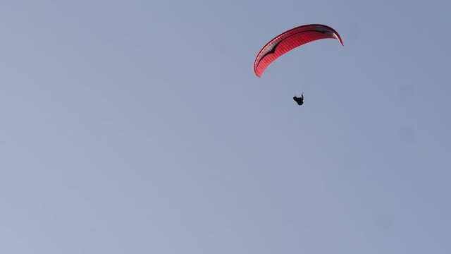 Paragliding. Extreme sport. Paraglider silhouette flying in the sky. Spain Alicante Santa Pola region.