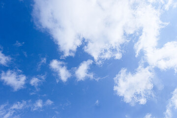 Naklejka na ściany i meble Bright blue sky with snow-white clouds speak of purity and freshness.
