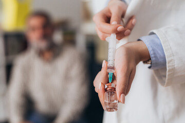 close up of woman doctor holding vaccine, corovnavirus concept