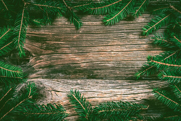 Pine leaves decoration on wood plank, frame border design. Merry Christmas and New Year holiday background. top view.