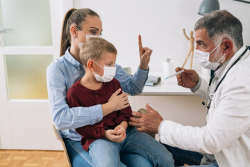 mother with her child refuse to receive coronavirus vaccine at the doctor office