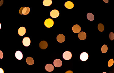 Bright bokeh from christmas garlands on dark background.