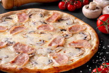 pizza on black background with ingredients