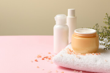 Fototapeta na wymiar Concept of spa cosmetics on pink table