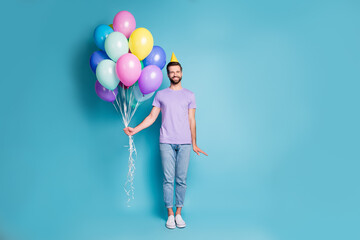 Full length body size photo of funny birthday man with balloons wearing yellow cone smiling...