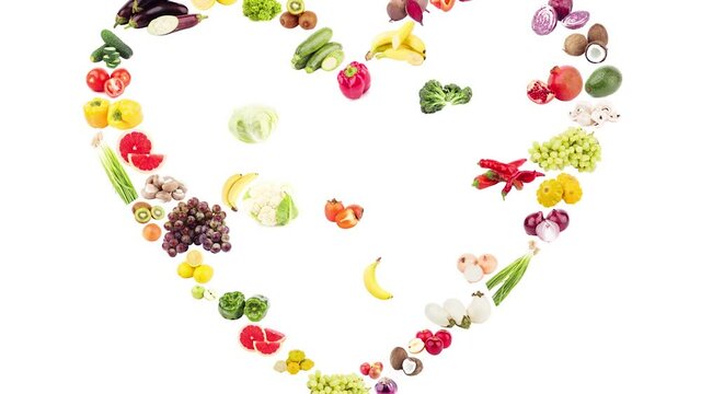 Stop motion. Big set of colored fruits and vegetables in the shape of heart, on the white background