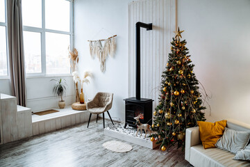 new year's interior of the apartment fireplace Christmas tree sofa garland, cozy atmosphere of a home holiday, loft design of the room, daylight, green Christmas tree decorated with toys