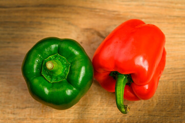 Colored bell peppers on wooden table