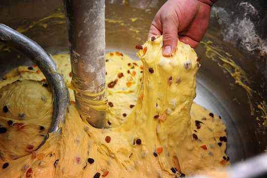 preparation of the typical Italian Christmas cake panettone, the candies are poured into the dough