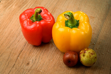 Colored bell peppers on wooden table