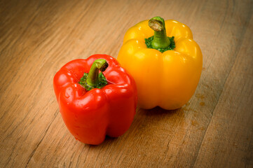 Colored bell peppers on wooden table