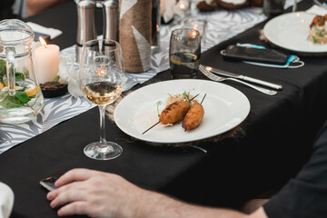 man eating juicy meat cutlets with a crisp on a ceramic plate with rice