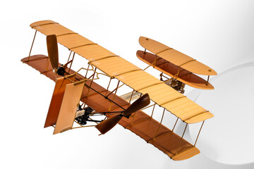 Creative Still Life Image Featuring A Wooden Vintage Toy Airplane  Floating and Isolated In A White Space. © LEEPOWERS