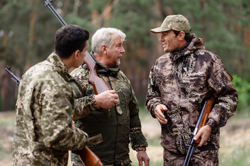 Men with Hunting Rifles Hunters Have Fun Outdoor.