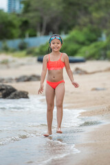 child relaxing on the beach against sea and sky background. summer vacation and travel concept. happy little girl running on the beach.